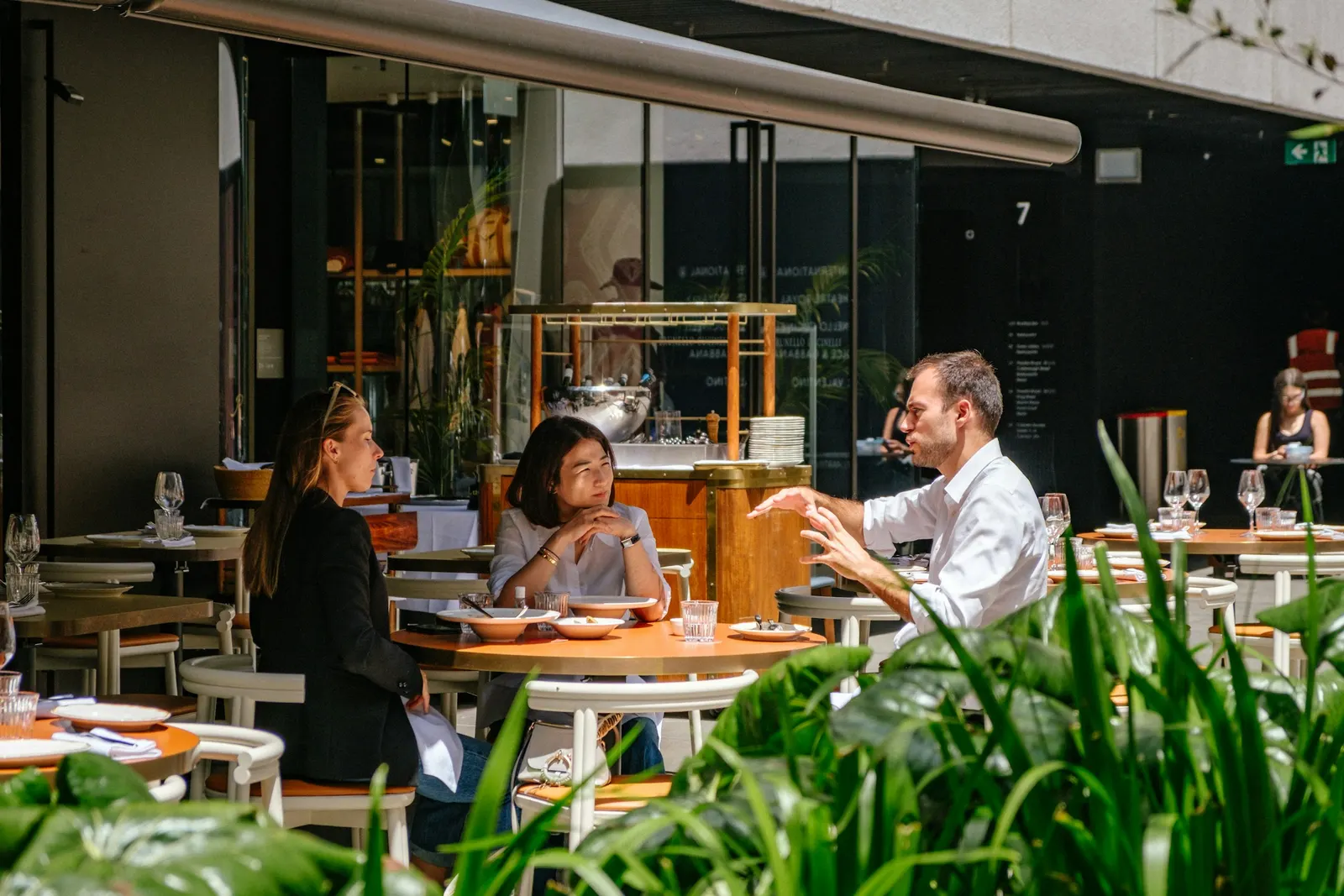 People dining together at an outdoor cafe in daylight