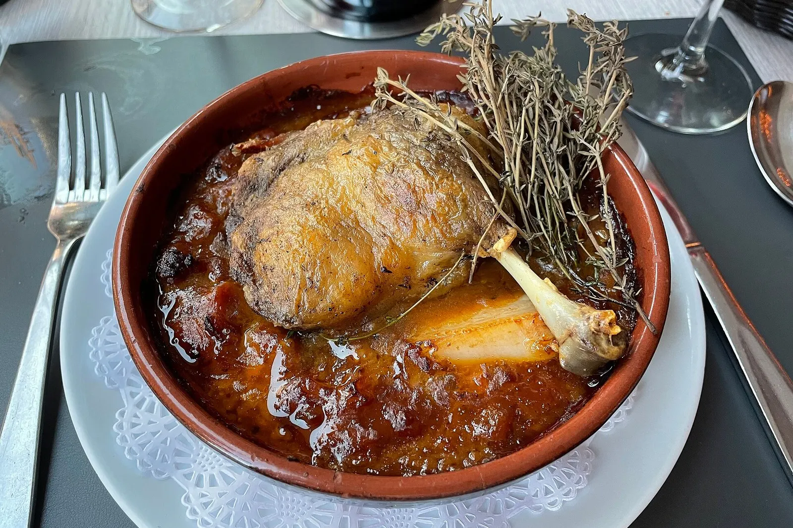 Cassoulet baked in an earthenware cassole with a confit duck leg and a browned crust