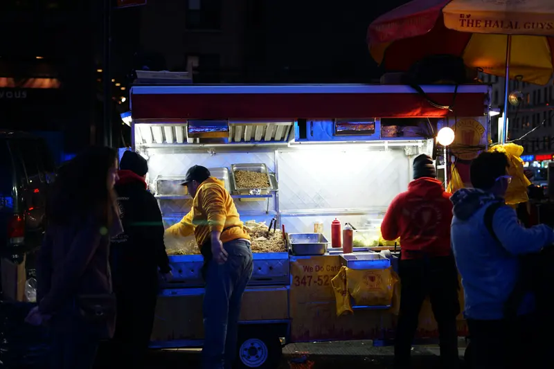 A New York City street food stall at night