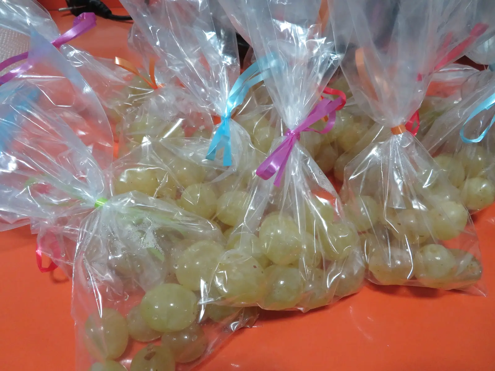 Bags of twelve green grapes tied with coloured ribbon, sold pre-portioned in Spain for New Year's Eve