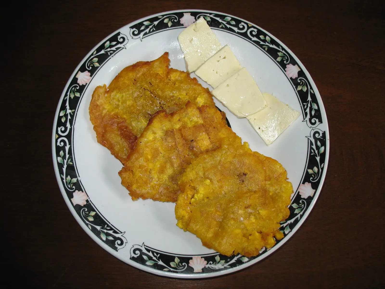 Patacones, fried green plantain, topped with crumbled salty white cheese, a Caribbean coast breakfast